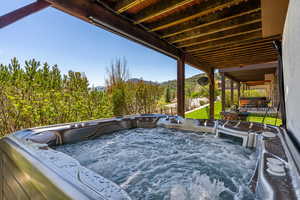 View of patio with a hot tub