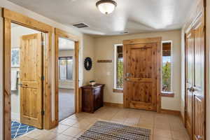 Foyer featuring baseboards and light tile patterned flooring
