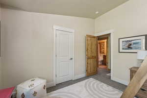 Carpeted bedroom with baseboards