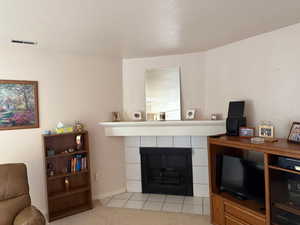 Living room featuring a tile fireplace