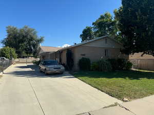 View of front of property with concrete driveway and brick siding