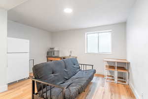 Sitting room with light wood-style floors and baseboards