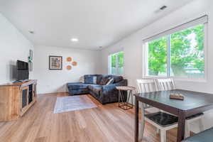 Living area featuring light wood-style flooring and baseboards