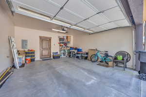 Garage with electric panel and a garage door opener