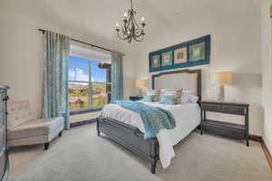 Bedroom with a chandelier, carpet floors, baseboards, and vaulted ceiling