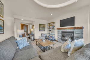 Living area with a stone fireplace and recessed lighting