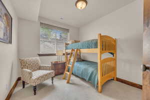 Carpeted bedroom featuring baseboards