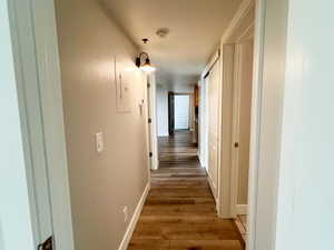 Hallway with wood finished floors and baseboards