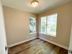 Unfurnished room with light wood-style flooring and baseboards