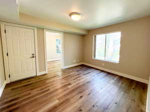 Empty room featuring wood finished floors and baseboards