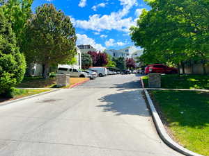 View of concrete road featuring curbs and a residential view
