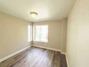 Unfurnished room featuring baseboards and wood finished floors