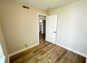 Unfurnished room featuring wood finished floors and baseboards