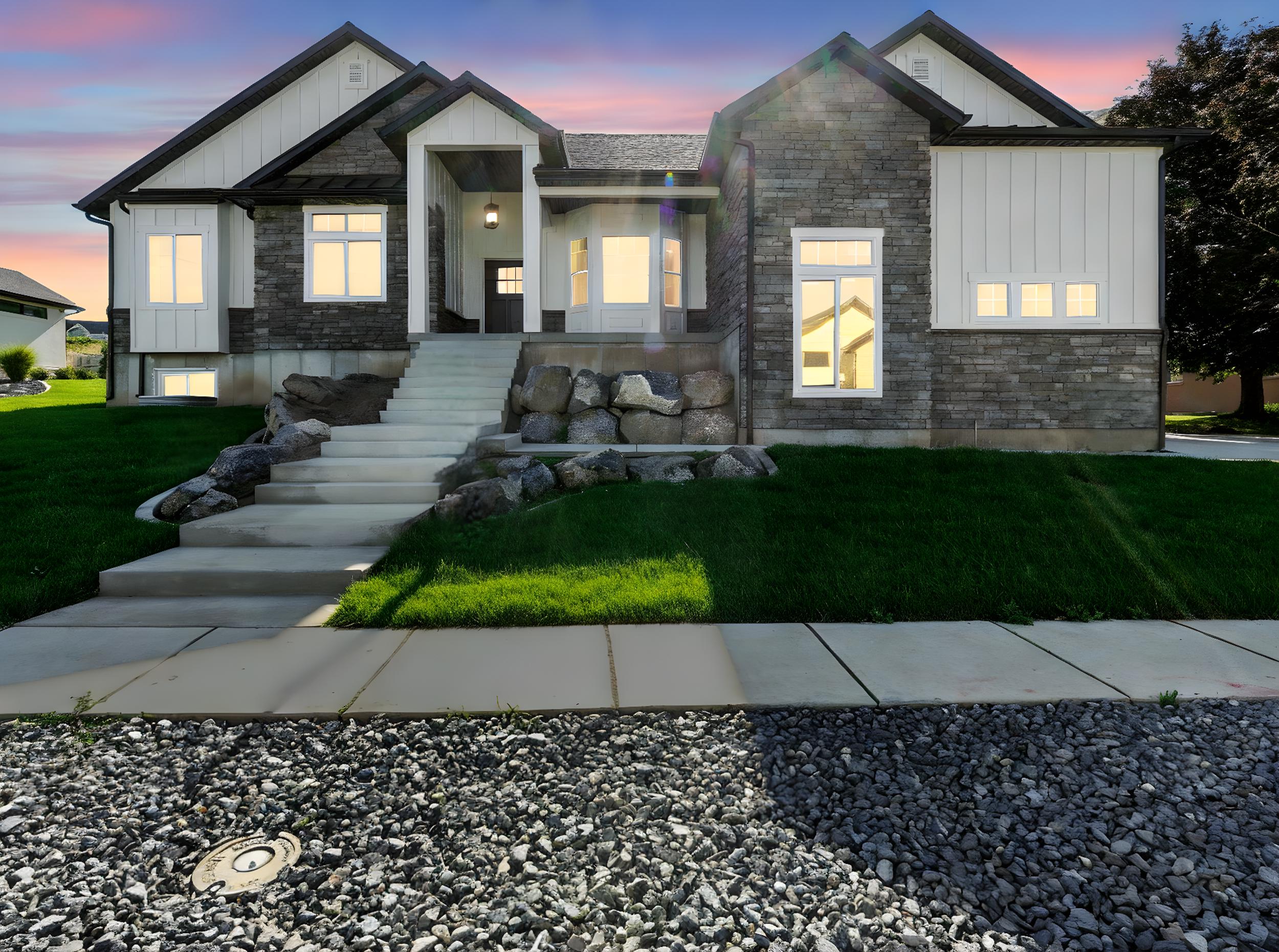 Modern inspired farmhouse featuring board and batten siding, stone siding, and a yard