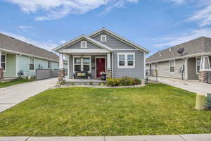 View of front of home with a porch and a front lawn
