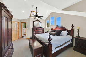 Bedroom with light carpet, lofted ceiling, baseboards, and recessed lighting