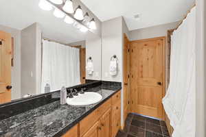 Bathroom with vanity and tile patterned flooring