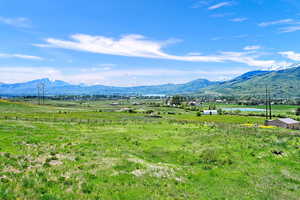 View of mountain backdrop with rural landscape