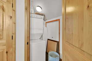 Laundry room featuring stacked washer / dryer