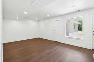 Unfurnished room featuring dark wood-style flooring and recessed lighting