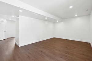 Finished below grade area featuring recessed lighting and dark wood-style flooring
