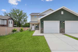 View of front of home featuring stone siding, stucco siding, driveway, and a garage