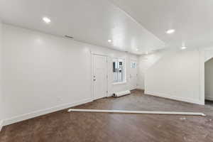 Entryway with baseboards, wood finished floors, and recessed lighting