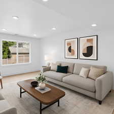 Living room with recessed lighting and light colored carpet