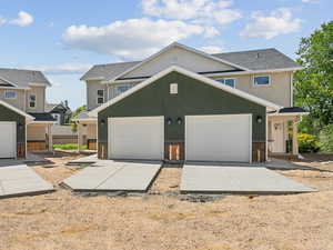 View of front facade featuring stucco siding and a garage