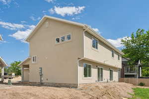 Back of house with stucco siding