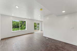 Unfurnished room featuring baseboards, recessed lighting, and dark wood-style flooring