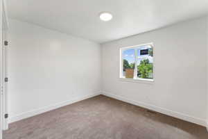 Unfurnished room featuring carpet floors and baseboards