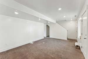 Finished basement with stairway, baseboards, and recessed lighting