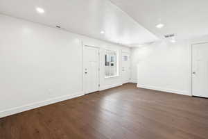 Foyer with dark wood-style flooring and recessed lighting