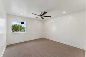 Empty room featuring ceiling fan, carpet, baseboards, and recessed lighting