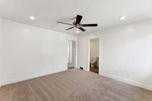 Unfurnished bedroom featuring recessed lighting, carpet floors, baseboards, ensuite bathroom, and ceiling fan
