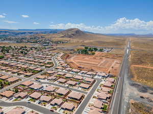 Aerial view of property's location with a mountain backdrop and nearby suburban area