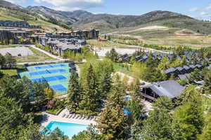 Drone / aerial view of a pool and a mountain backdrop