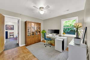 Office featuring a ceiling fan and baseboards