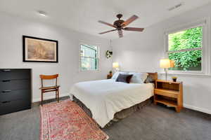 Carpeted bedroom featuring baseboards and a ceiling fan