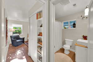 Full bathroom featuring toilet, vanity, curtained shower, and baseboards