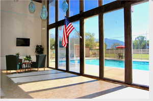 Doorway to outside featuring a mountain view and a towering ceiling