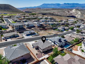 Aerial perspective of suburban area featuring a mountainous background