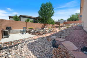 Fenced backyard featuring a patio and a fire pit