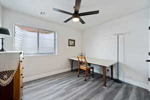 Office with a ceiling fan, wood finished floors, and baseboards