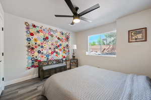 Bedroom with wood finished floors, baseboards, and ceiling fan