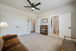 Sitting room featuring a ceiling fan, carpet floors, and baseboards