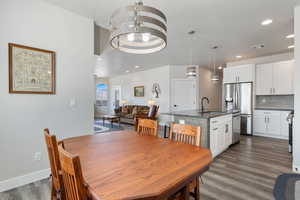 Dining space featuring dark wood-style floors, recessed lighting, and baseboards