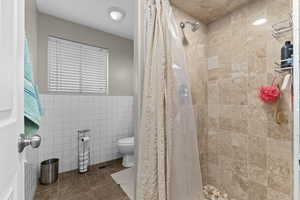 Bathroom adjacent to laundry and mudroom
