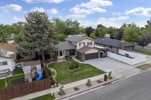 View of front facade featuring driveway, a garage, and a residential view